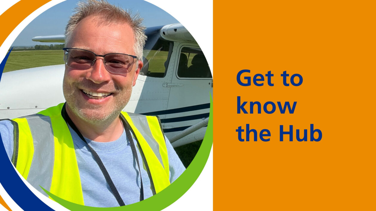 Darren in a high visibility jacket in front of a jet.