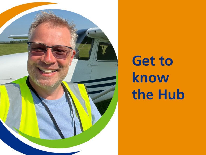 Darren in a high visibility jacket in front of a jet.